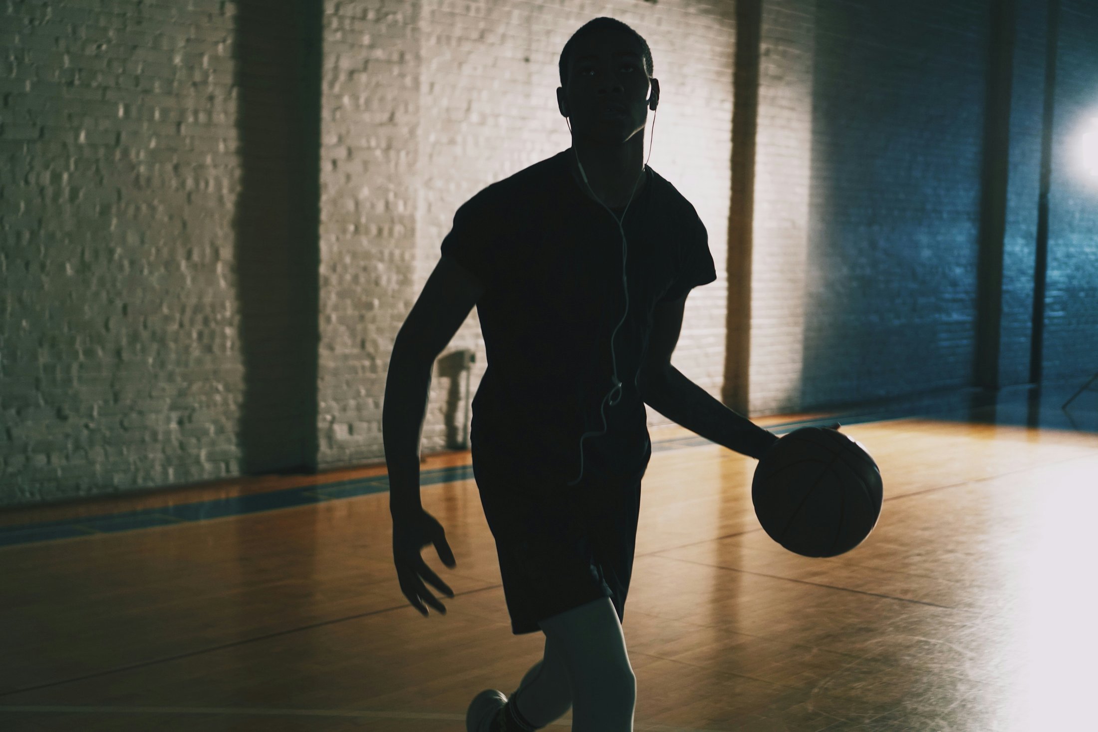 Basketball player holding a ball on an indoor court